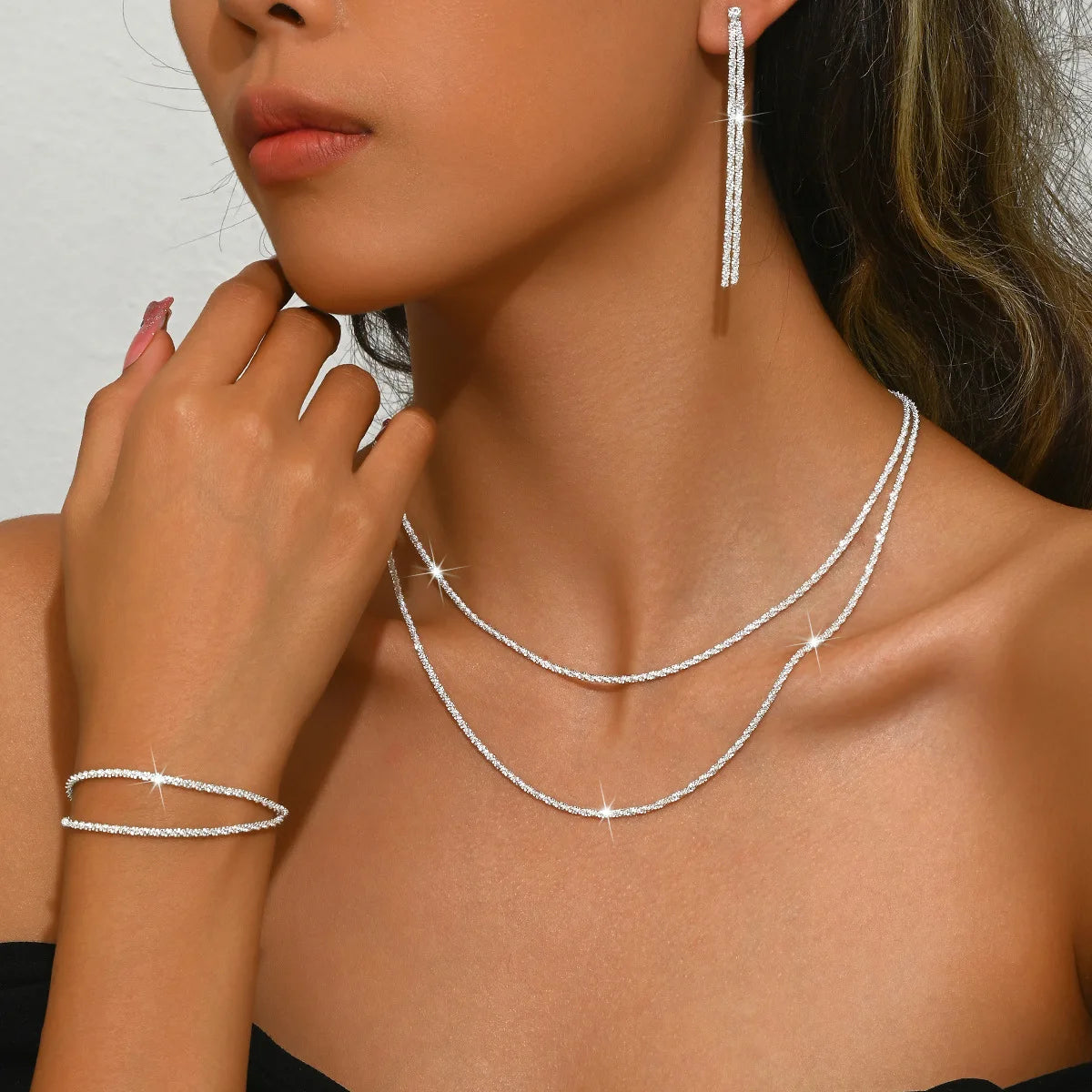 Set di collana e bracciale placcati argento, design minimal con dettagli ispirati al cielo stellato. Accessori eleganti perfetti per un look femminile raffinato.